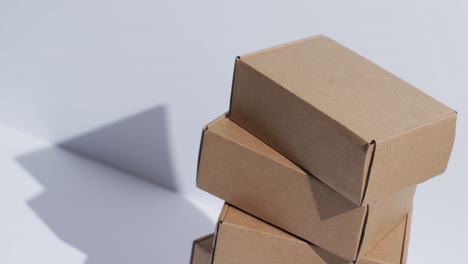 video of stacked cardboard boxes with copy space over white background