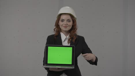 woman engineer presenting laptop with green screen