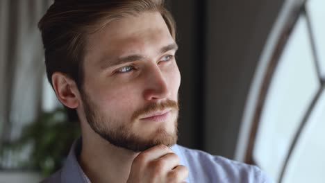 worried thoughtful young businessman looking away thinking of future