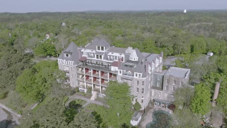 aerial view of a grand historic hotel surrounded by forest