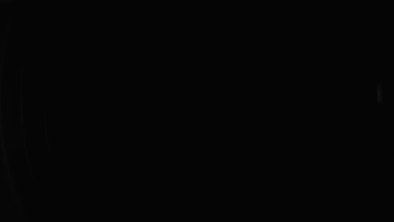 A beam of light illuminates the front lens of the camera lens