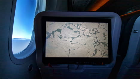 view of the ground below the airplane during the flight on a monitor display