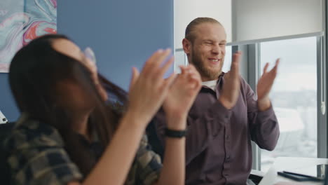 Excited-freelancers-rejoicing-success-at-office.-Positive-couple-giving-five