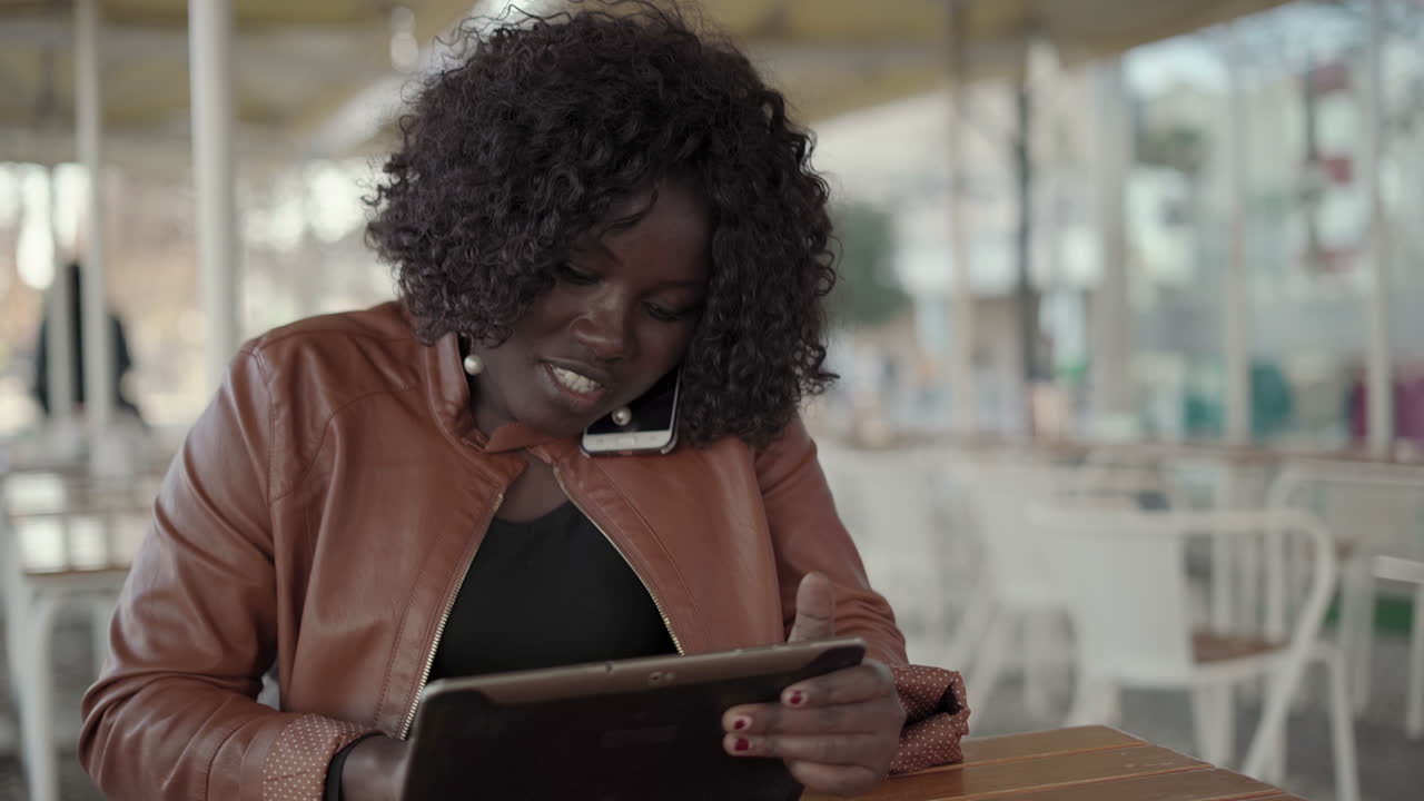 Young woman using smartphone and digital tablet