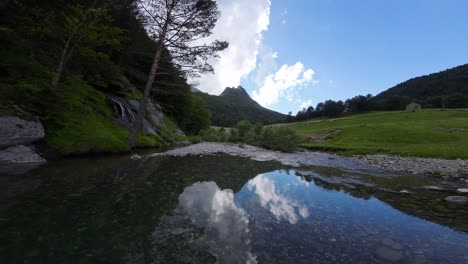 spectacular aerial image of a drone flying over a river, mountain, and waterfall