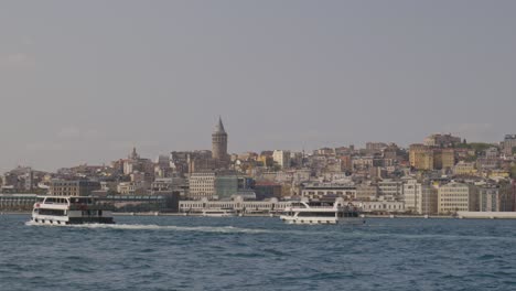 Ferry-passenger-boats-cruise-Golden-Horn-with-Galata-Tower-city-backdrop