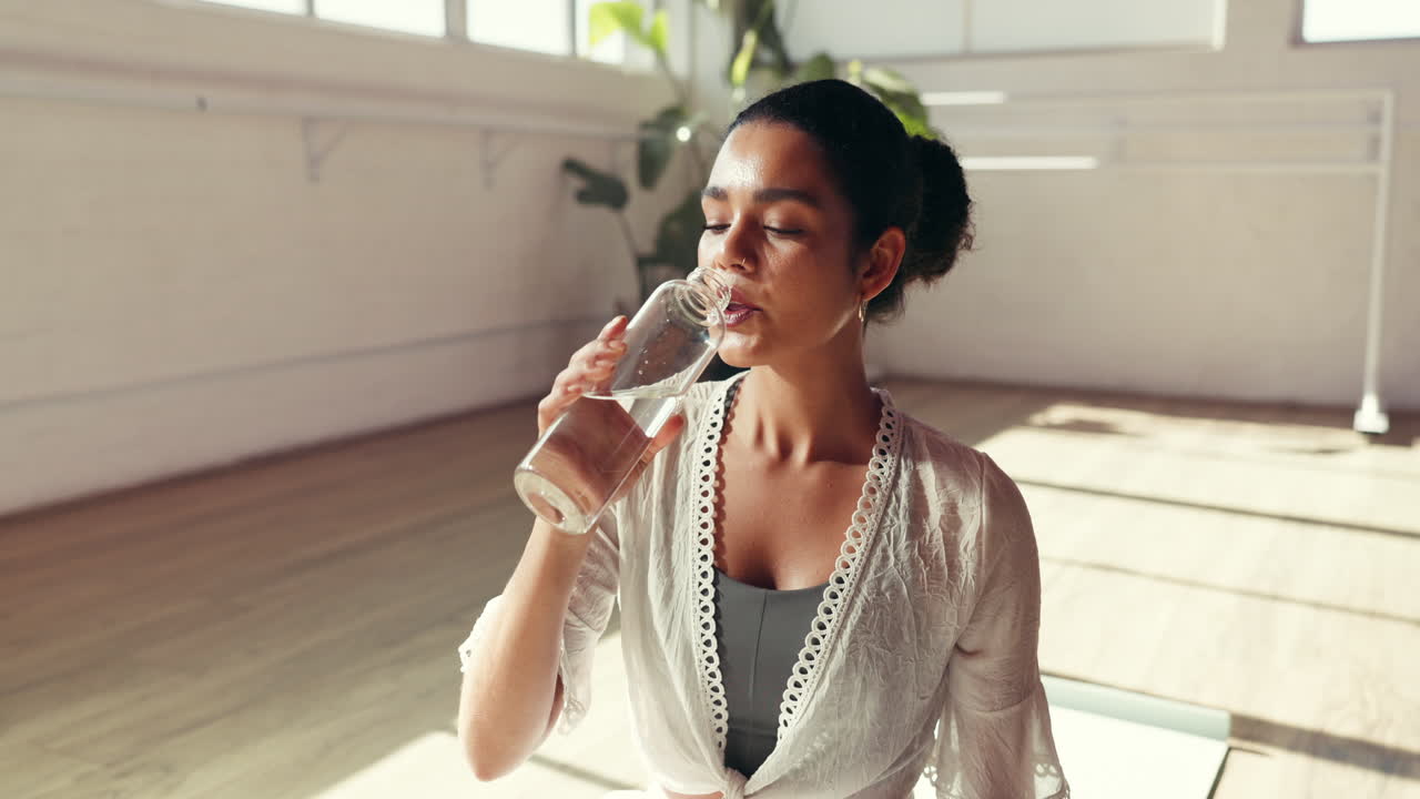 Woman drinking water indoors