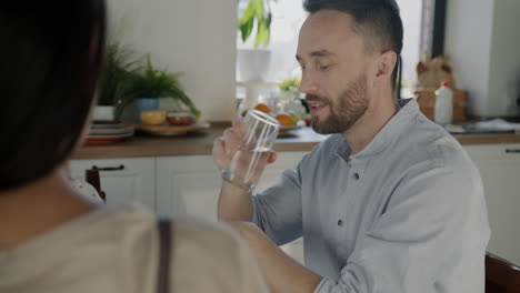 couple having a conversation in a kitchen