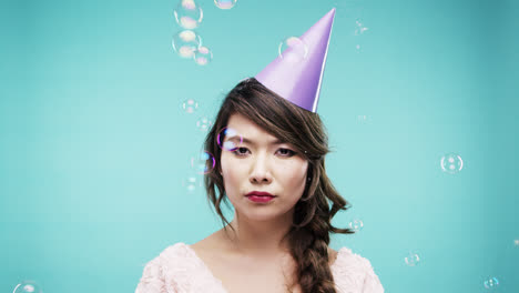 Single-woman-is-sad-in-bubble-shower-slow-motion-photo-booth-blue-background