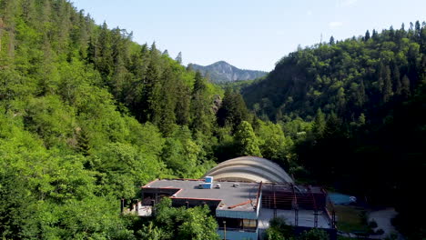 the leafy area around a mineral spring and an empty amusement park nestled in a valley amongst a forest