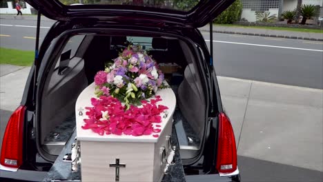 closeup shot of a funeral casket in a hearse or chapel or burial at cemetery