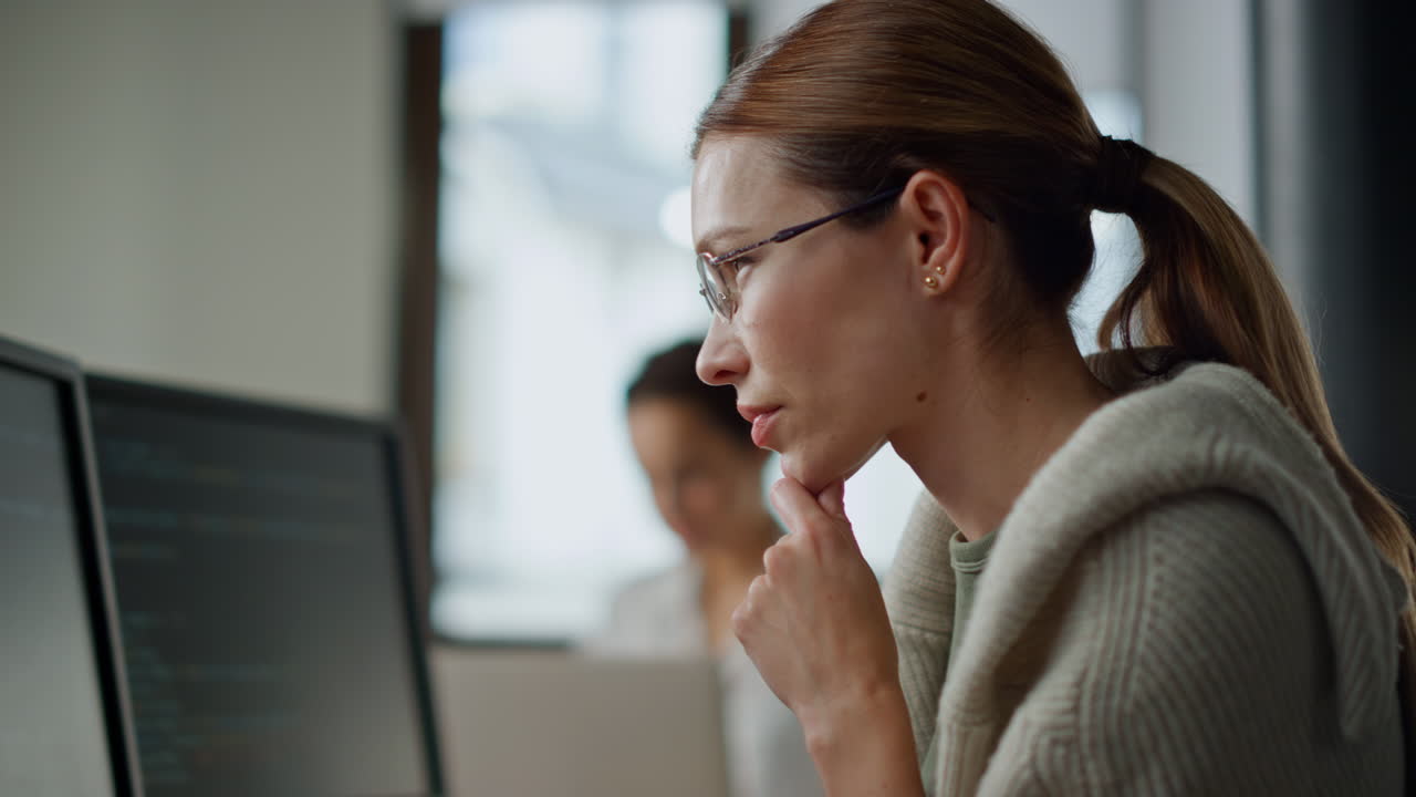 Woman developer checking code closeup. Focused software engineer work computer