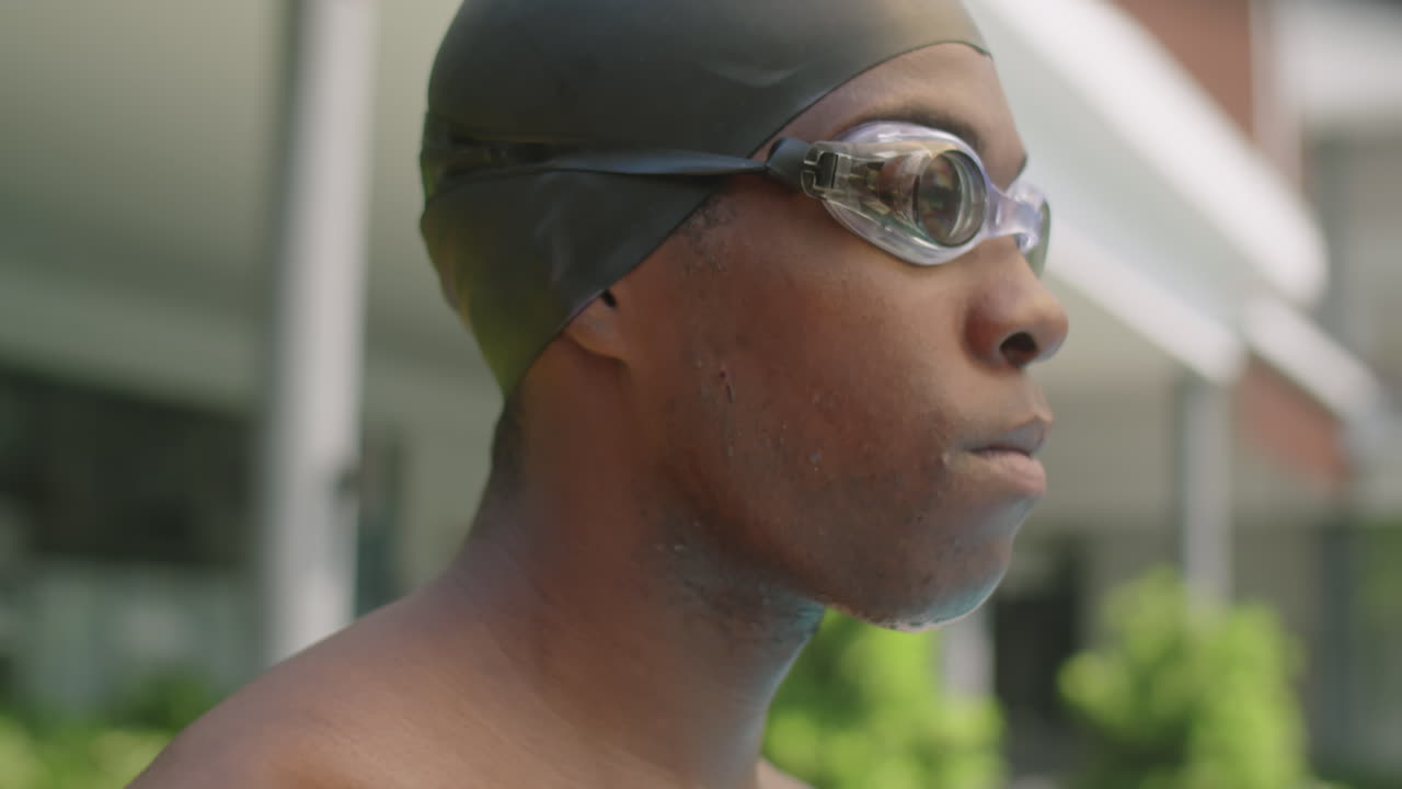 African American Swimmer Putting on Goggles