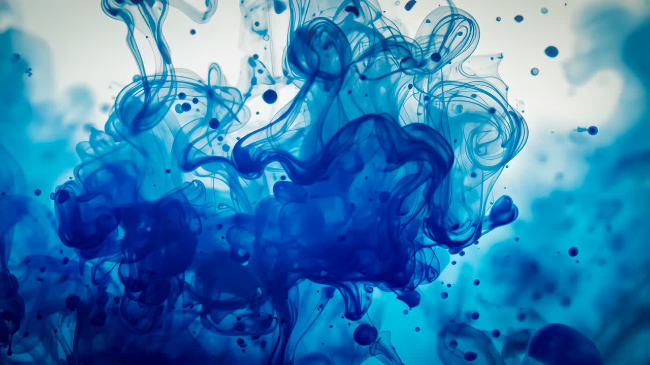 Injecting deep blue dye into glass water vessel, forming swirling plume creating diffusion pattern