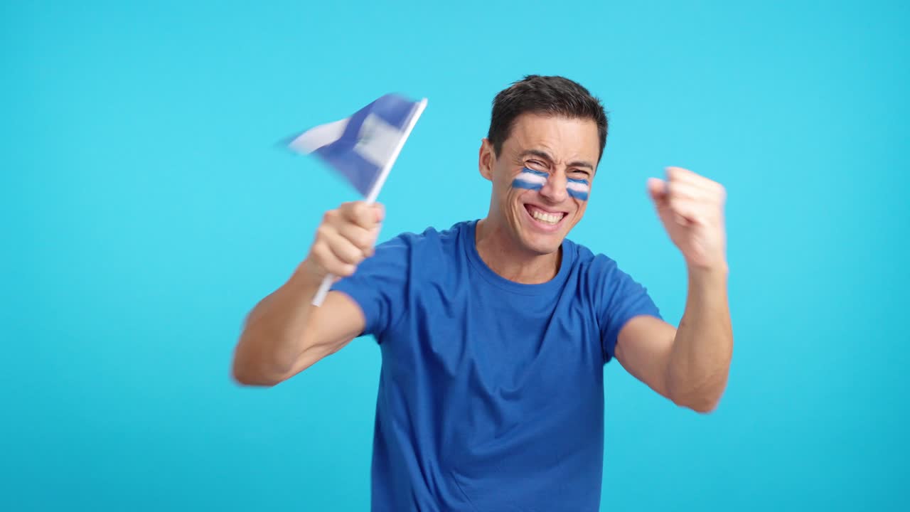 Man cheering for El Salvador screaming and waving a national flag