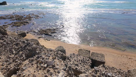 Rocky-coastline-under-shimmering-sunlight