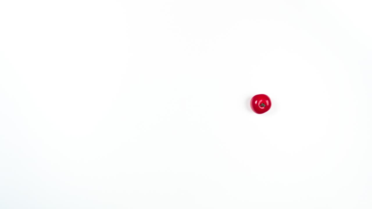 4k Load up on healthy vegetables. Red tomato moves in a circle, turning into a few tomatoes. Creative stop motion animation. Program load loop.