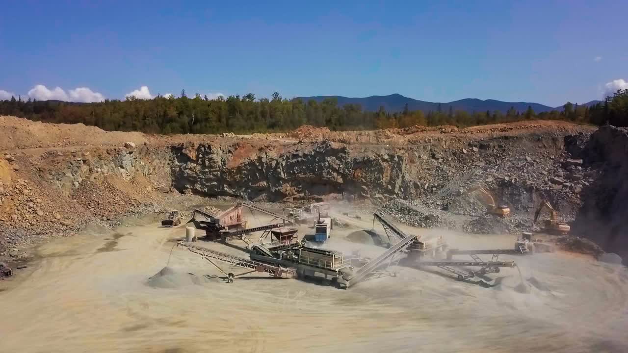 Grand overview of rock crushing construction site in rock pit gravel quarry (HD 30p)