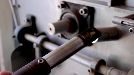 A-closeup-of-barista-checking-on-coffee-beans-during-coffee-roasting-production-in-industrial-coffee-roaster-machine-at-local-cafe