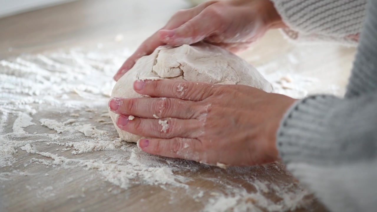 Kneading bread dough by hand in home kitchen