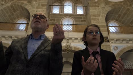 family praying with hands