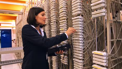 Female-technician-using-digital-cable-analyzer