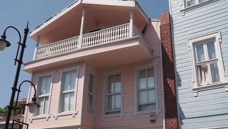 pink and blue house with balcony