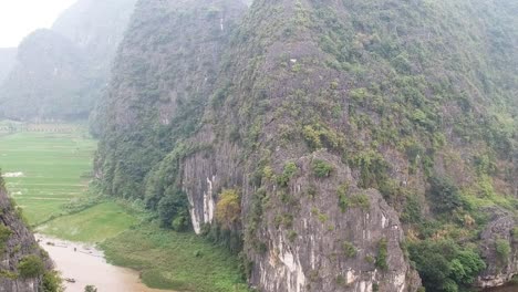 aerial of river between limestone karsts near trang ang