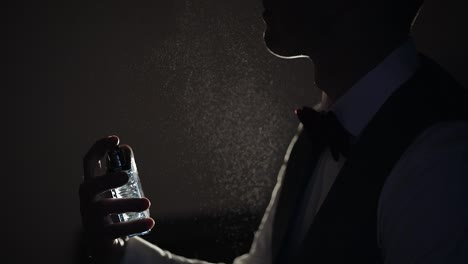 groom splits perfume or deodorant on hisself, wedding day, slow motion, well dressed businessman