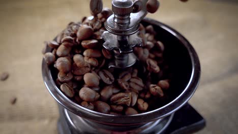 coffee beans fall in the old grinder. slow motion with rotation tracking shot.