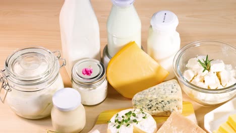 various dairy products arranged on wooden surface