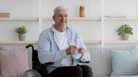 man in wheelchair adjusting face mask