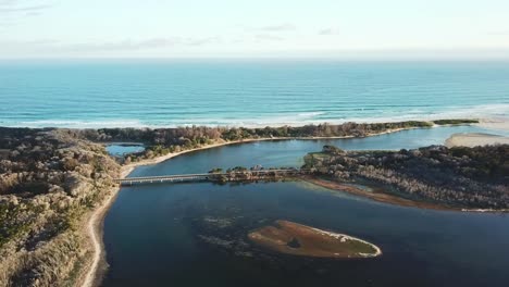 Sideways-drone-footage-in-the-late-afternoon-over-the-mouth-of-the-Betka-River-in-eastern-Victoria,-Australia,-December-2020