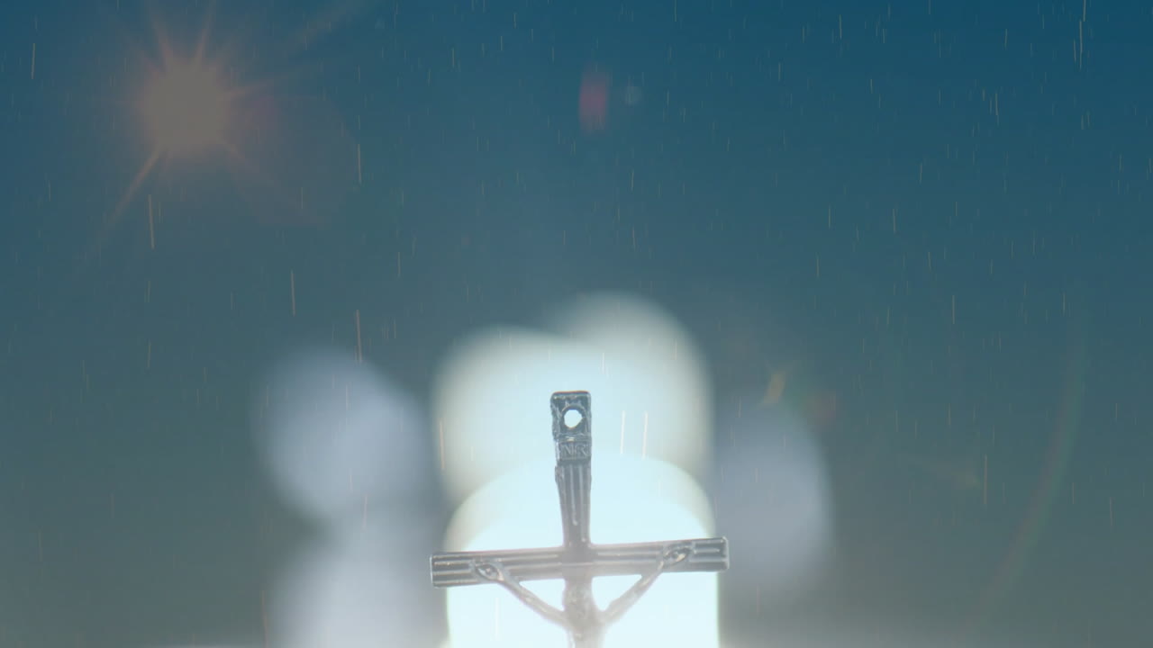 Floating bubbles around crucifix with illuminated background creating animation effect