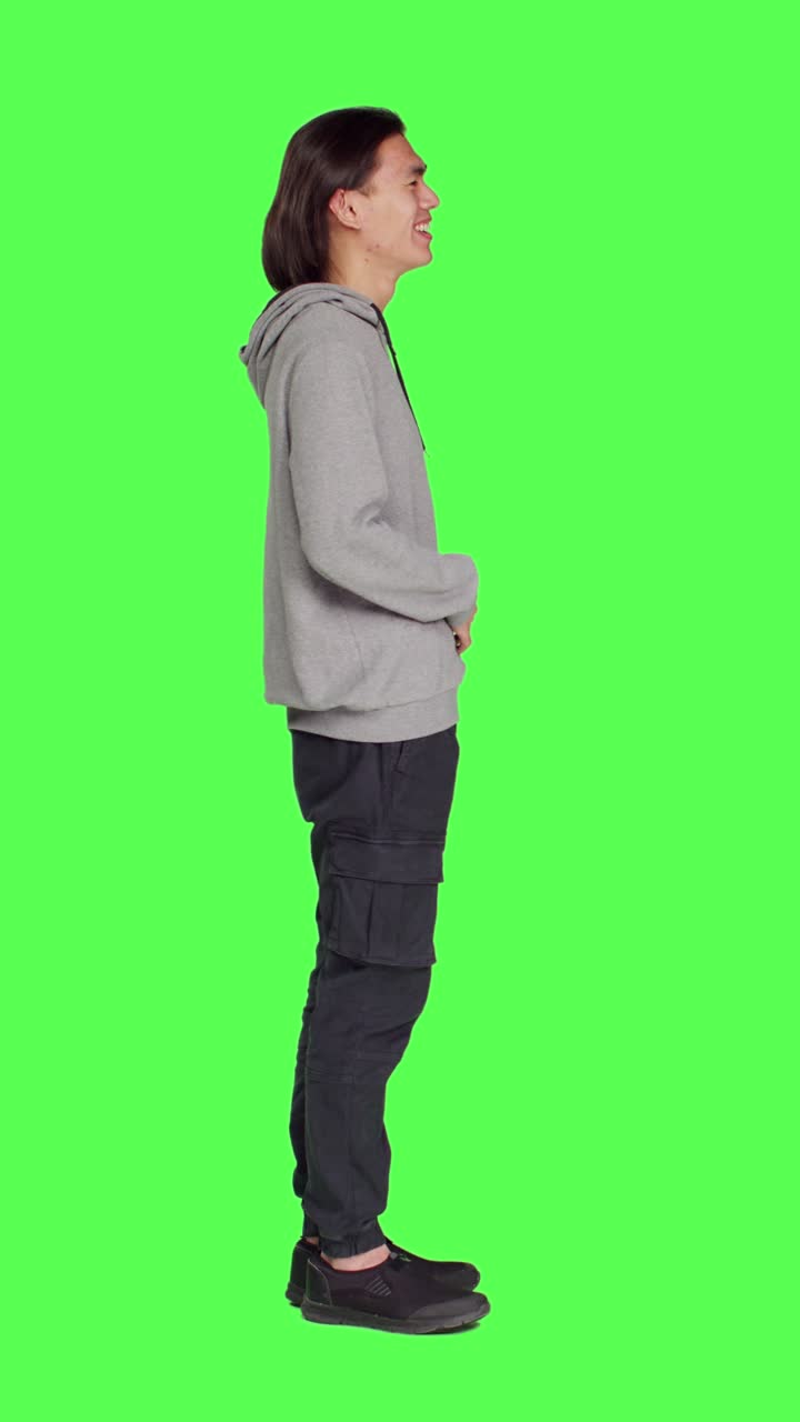Profile of cheerful male model laughing in studio