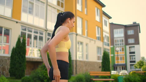 tired woman regains strength after training with headphones