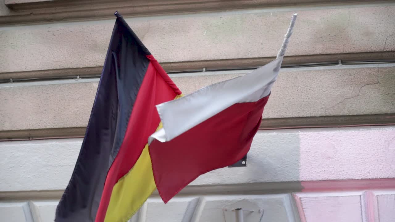 German and polish flags waving on wind