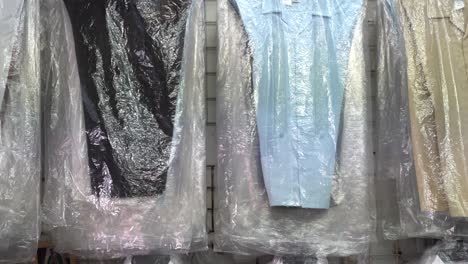 camera pans up showing assortment of guayabera men’s shirts in a shop in merida mexico