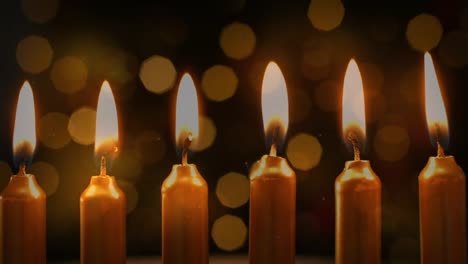 animation of lit candles with flickering lights in the background