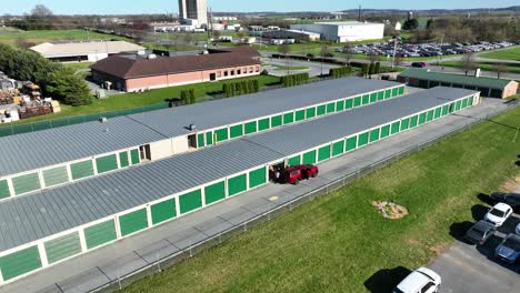 Panoramic-aerial-view-of-self-storage-units-with-people-using-the-facility,-Mount-Joy-Downtown,-Pennsylvania,-USA