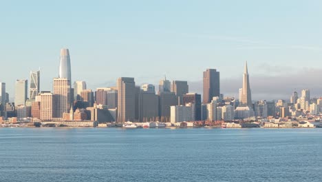 sleek lines of urban development run parallel to the gentle arc of the waterfront in this high-elevation pass.