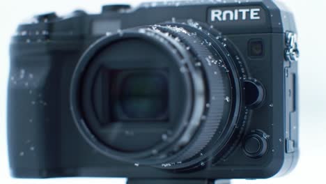 a compact camera captures the beauty of winter with snowflakes settling on its surface. unique details highlight its resilient design against cold and moisture while showcasing stunning imagery.