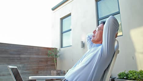 Asian-man-relaxing-in-his-garden