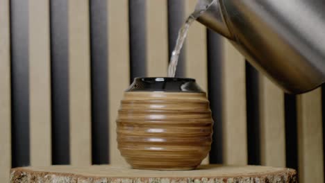 Water-from-a-kettle-is-poured-into-the-gourd-with-yerba-mate