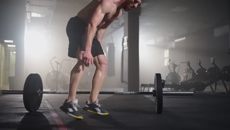 Fitness-man-doing-burpee-workout-at-gym.-Medium-shot-of-young-man-doing-push-ups-and-jump-exercise-in-slow-motion.-Sport-concept