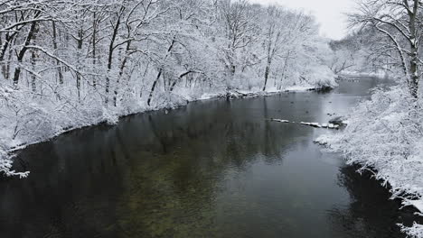 A-drone's-cinematic-sweep-above-the-snow-laden-Huron-River-Valley-landscape