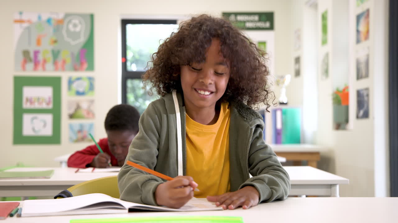 Smiling child writing in classroom, enjoying school activities with friends