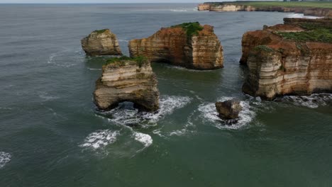 close-up drone footage of the orange colored rocks around the great ocean road in victoria, australia