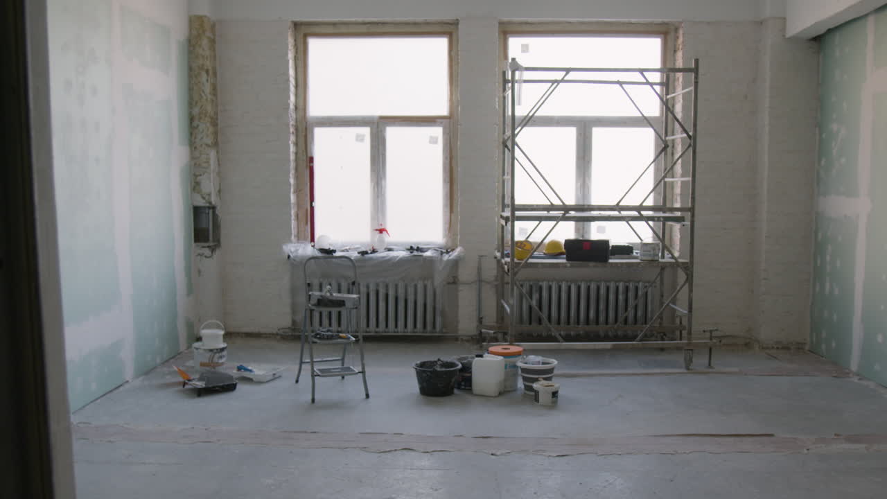 Room Renovation with Scaffolding and Paint Supplies