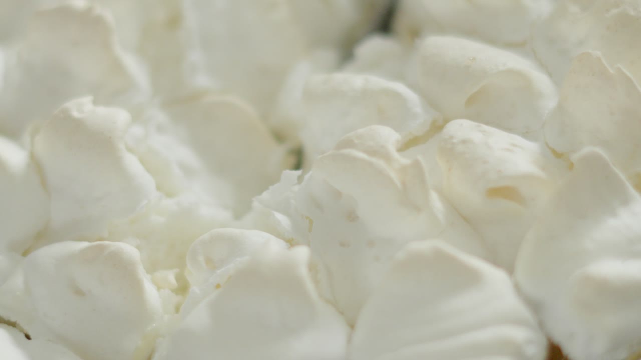 Top View of Meringue Cracking in Slow Motion as Knife Gently Cuts Through to Soft Lemon Curd Below. Close Up of Indulgent Sweet Homemade Dessert Food. High in Sugar and Flavour